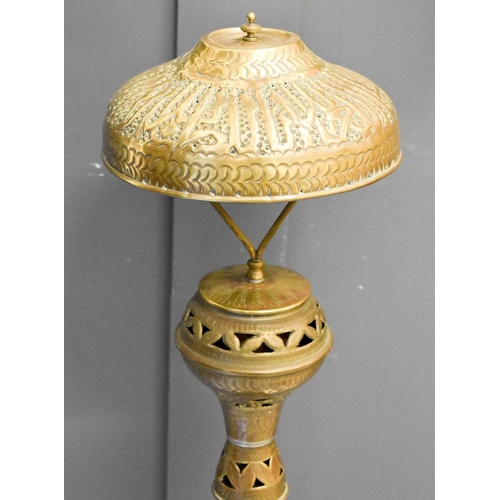 573 - A 19th century brass Indonesian lamp, possibly converted from a lantern, embossed with decoration,11... 