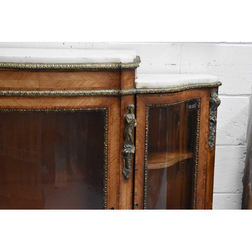 582 - A French 19th century walnut, ormolu and marble topped credenza, with shaped bow front, central glaz... 