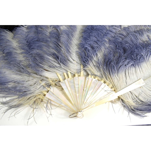 86 - An early 20th century ostrich feather fan with Art Deco mother of pearl handle, the plumes edged wit... 