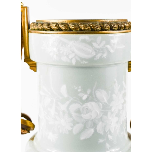 96 - A 19th century French Pâte-sur-pâte and ormolu twin handled urn, pale green with white overlay, the ... 