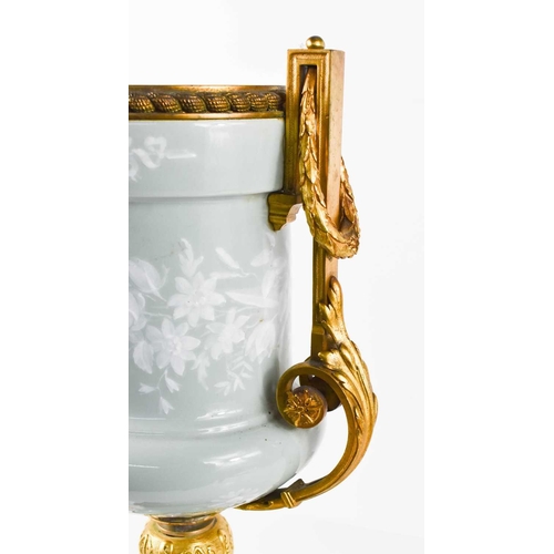 96 - A 19th century French Pâte-sur-pâte and ormolu twin handled urn, pale green with white overlay, the ... 