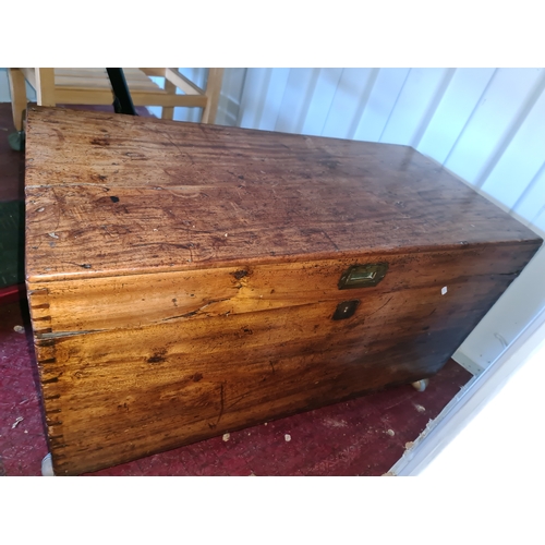 592 - A 19th century pine chest, with iron handles and raised on castors.