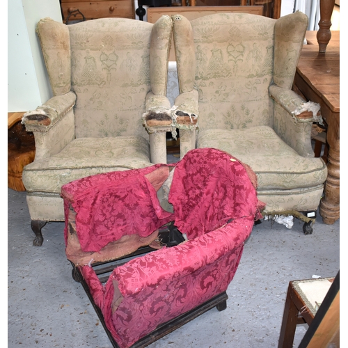 544 - A apir of Victorian wingback armchairs, raised on oak ball and claw feet together with a childs tub ... 