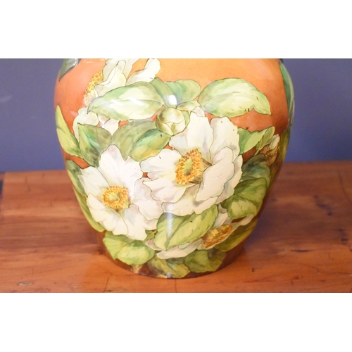 216 - A Moorcroft lamp base, together with a pair of twin handled vases, decorated with white flowers on a... 