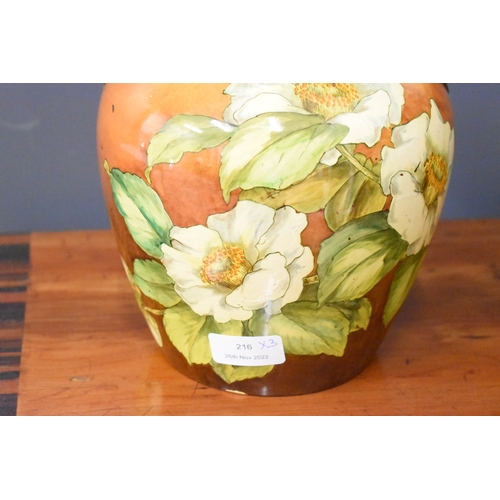 216 - A Moorcroft lamp base, together with a pair of twin handled vases, decorated with white flowers on a... 