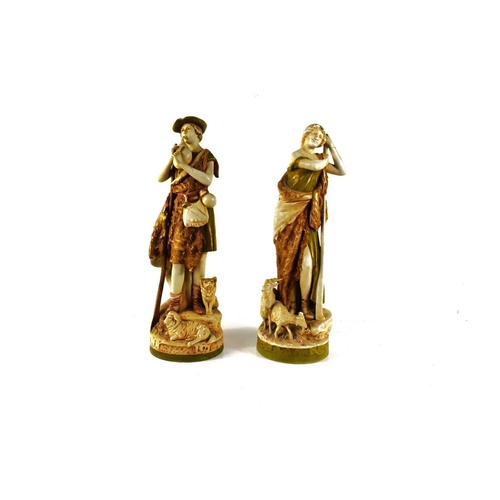 138 - A pair of early 20th century Royal Dux figures of a shepherd and shepherdess, he playing a pipe, and... 