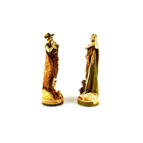 138 - A pair of early 20th century Royal Dux figures of a shepherd and shepherdess, he playing a pipe, and... 