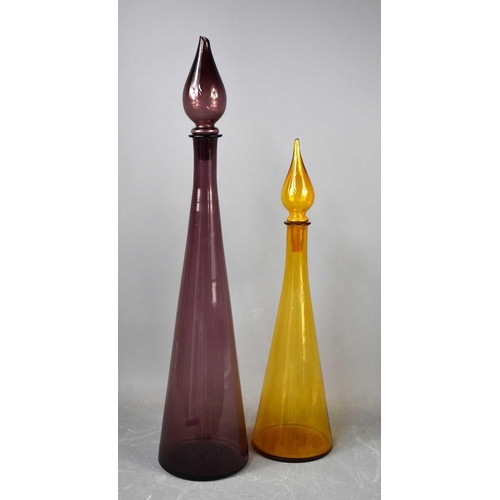 151 - Two early 20th century tall coloured glass decanters with stoppers.