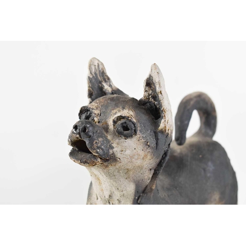 17 - A clay stoneware sculpture of a standing dog on a rectangular base, apparently unsigned.