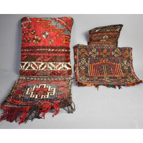 68 - Two Middle Eastern, circa 1900 camel bags (35cm x 38cm, 60cm x 45cm), and a cushion (39cm x 46cm)