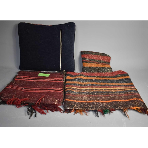 68 - Two Middle Eastern, circa 1900 camel bags (35cm x 38cm, 60cm x 45cm), and a cushion (39cm x 46cm)