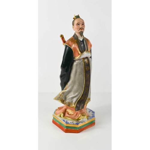 9 - A porcelain figure of a Japanese nobleman, with finely painted bisque face, wearing flowing robes, w... 