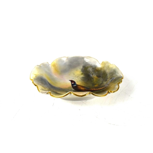 128 - James Stinton for Royal Worcester, a small pin dish, of wavy leaf form, hand painted with a cock phe... 