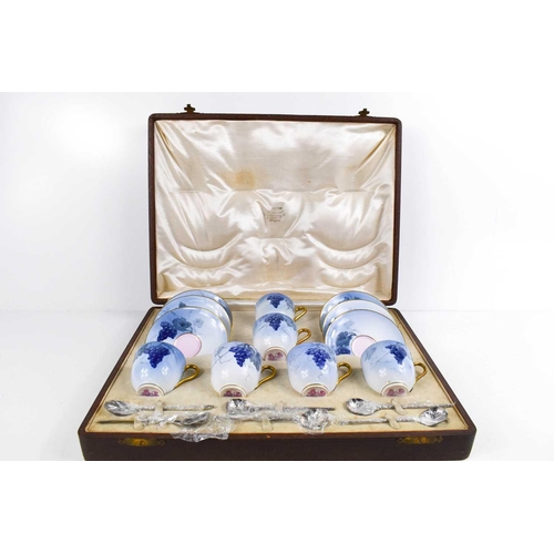 130 - A fine Royal Worcester set of coffee cans and saucers, painted with blue grape and vine decoration w... 