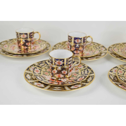 140 - A set of six Royal Crown Derby coffee cans and saucers with matching side plates (six trios) in the ... 