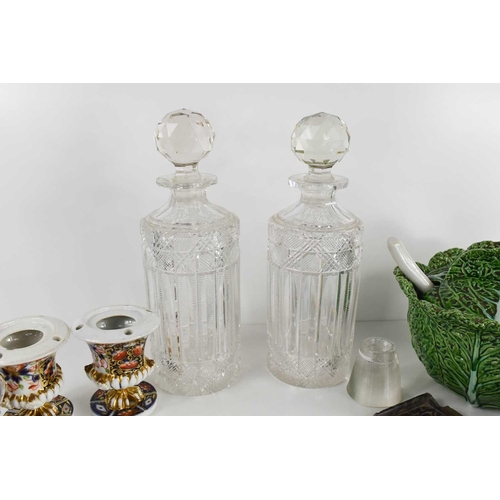 157 - A pair of antique cut glass decanters with the original stoppers, together with a silver topped glas... 