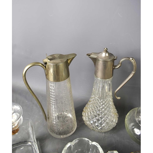 164 - A quantity of vintage glassware to include a number of decanters with stoppers, and two jugs fitted ... 