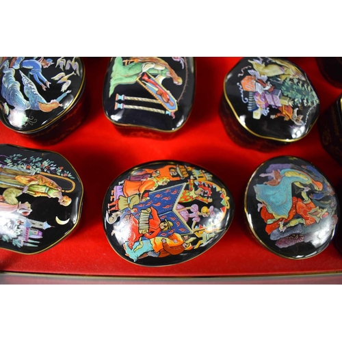 194 - A collection of Franklin Mint porcelain music boxes in a glass case.