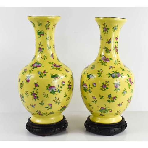 229 - A pair of Chinese vases, with yellow ground, depicting butterflies, grasshoppers, flowers and raised... 