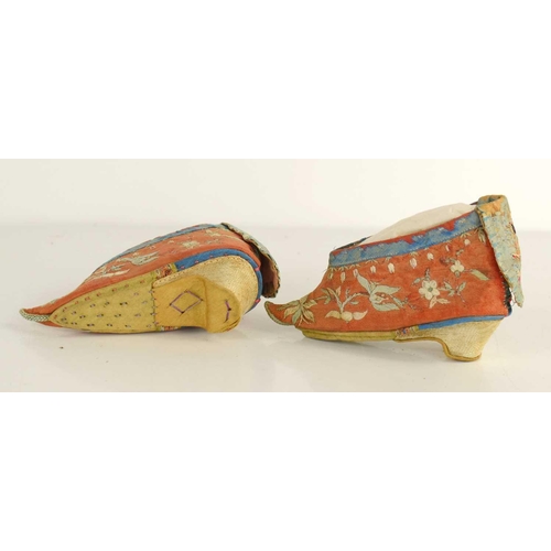 264 - A pair of Chinese bound feet shoes or 'lotus shoes', circa 1900, hand embroidered on red silk depict... 