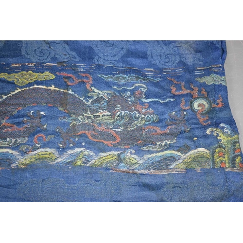 275 - A late 18th / early 19th century woven cloth with silk embroidered four clawed dragon and a cloud bo... 