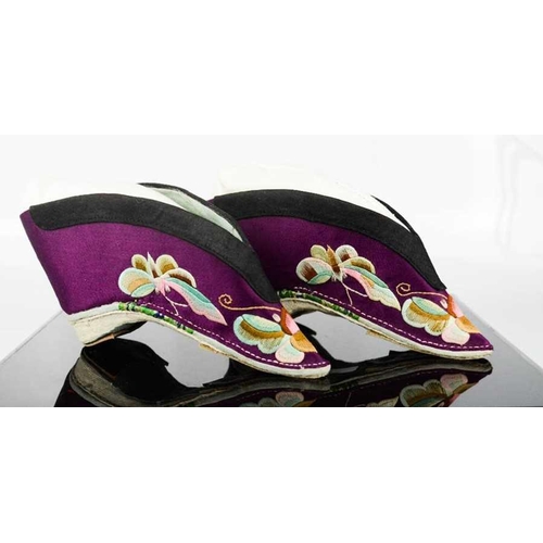 278 - A pair of Chinese silk lotus shoes, circa 1920, the purple silk embroidered to depict butterflies, 1... 