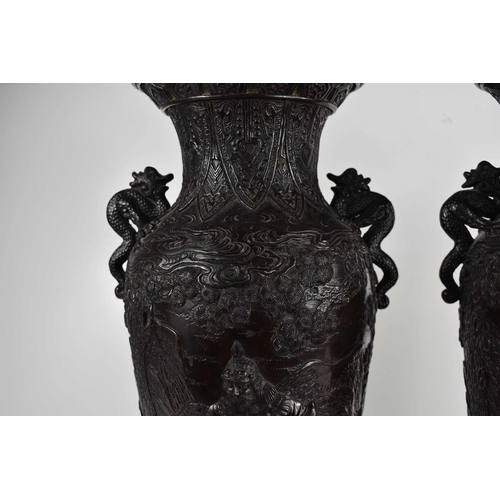 294 - A pair of 19th century Japanese bronze vases, cast in detail to depict Japanese Warriors in traditio... 