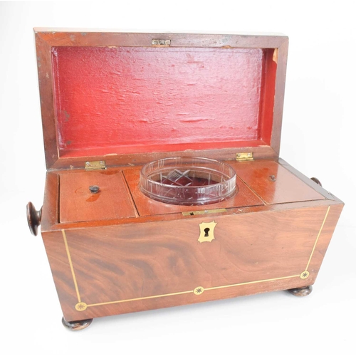 346 - A 19th century mahogany tea caddy with brass inlaid decoration, interior lids, glass bowl, and raise... 