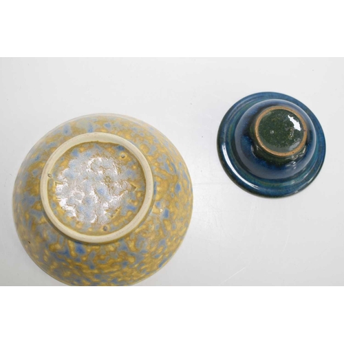 34a - A small Ruskin bowl with yellow underglaze and mottled blue overglaze indistinctly dated 1927 and im... 