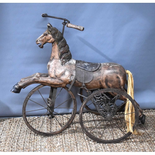 367 - A Victorian style child's Velocipede tricycle, the carved wood horse with horse hair tail, leather s... 