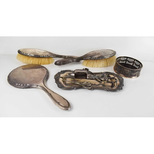 372 - A pair of silver clad hair brushes, with matching hand mirror, together with silver plated wine coas... 