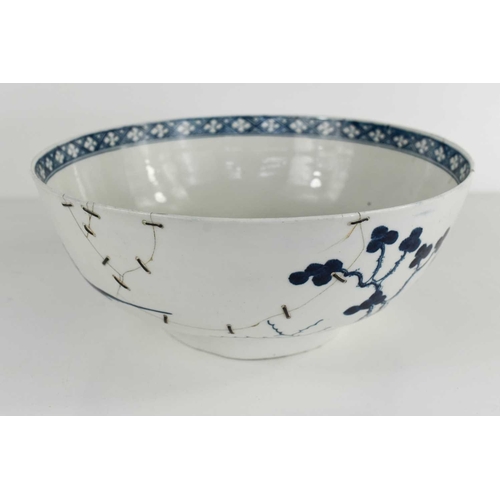 39 - An 18th century Worcester blue and white bowl, depicting a Chinese landscape, repaired with rivets, ... 