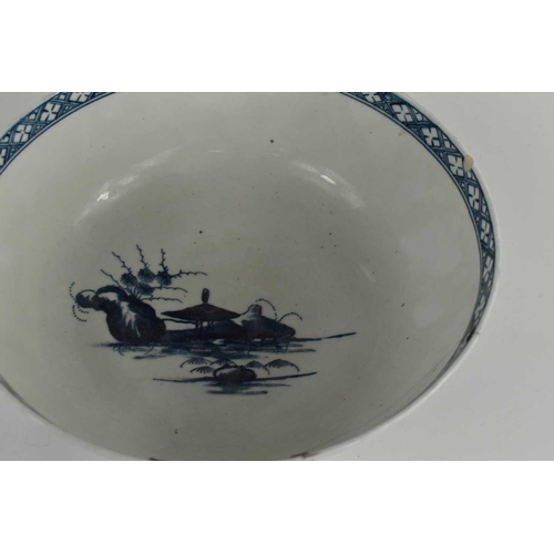 39 - An 18th century Worcester blue and white bowl, depicting a Chinese landscape, repaired with rivets, ... 