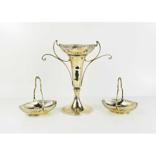 395 - A silver stem vase with matching bon bon baskets, the vase having shaped handles with curled fronds,... 