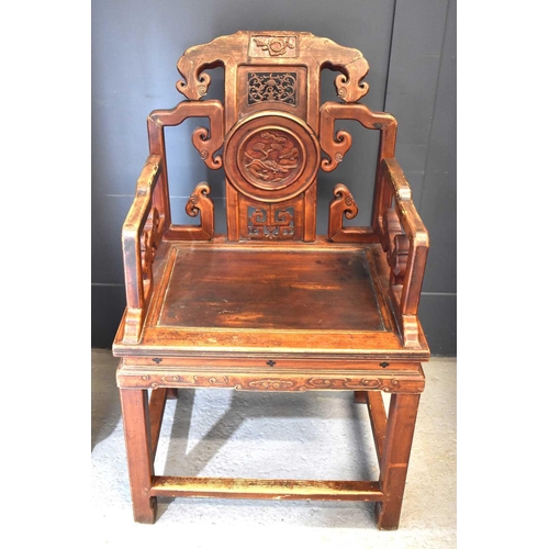 494 - A Chinese carved temple chair, the shaped back having decoratively pierced panels and a central roun... 