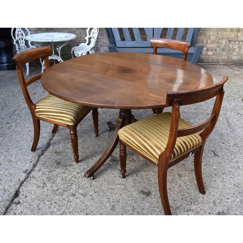 502 - A 19th century mahogany tilt top loo table raised on three reeded legs terminating with castors toge... 