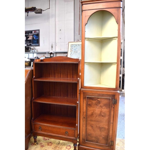 505 - A 20th century mahogany waterfall bookcase raised on turned legs with brass castors together with a ... 