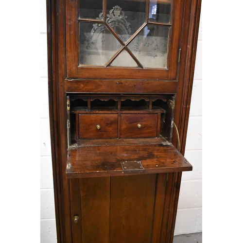 411 - An 18th century oak secretaire cabinet, the upper astragal glazed door enclosing two shelves and lin... 