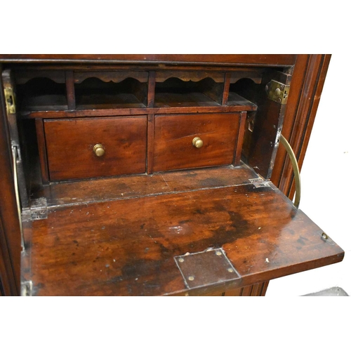 411 - An 18th century oak secretaire cabinet, the upper astragal glazed door enclosing two shelves and lin... 