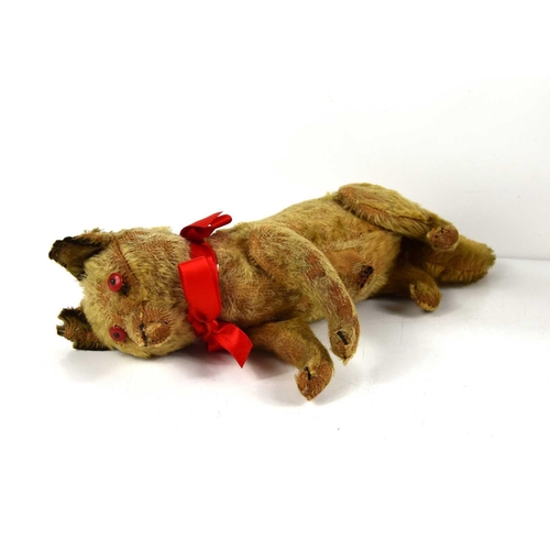 99 - An early 20th century, likely pre WWI toy fox, straw filled and rod jointed, with red button eyes, s... 