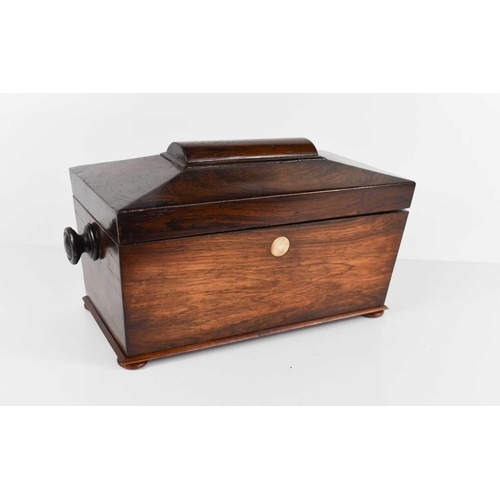 245 - A 19th century rosewood tea caddy, of sarcophagus form, the interior fitted with two lidded compartm... 