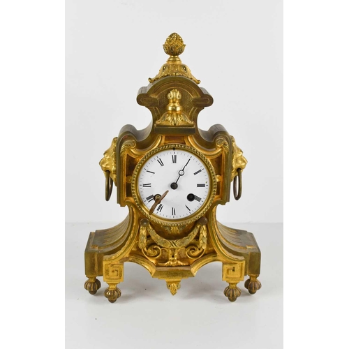 249 - A French 19th century gilt metal mantle clock, with enamel Roman Numeral dial, and two lion head and... 