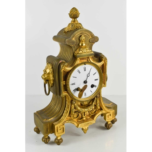 249 - A French 19th century gilt metal mantle clock, with enamel Roman Numeral dial, and two lion head and... 