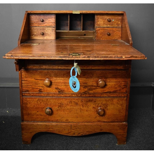 50 - An old Etonian Victorian elm bureau bearing residual student graffiti and key with Eton College tag,... 