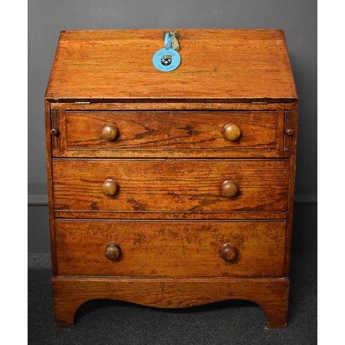 50 - An old Etonian Victorian elm bureau bearing residual student graffiti and key with Eton College tag,... 