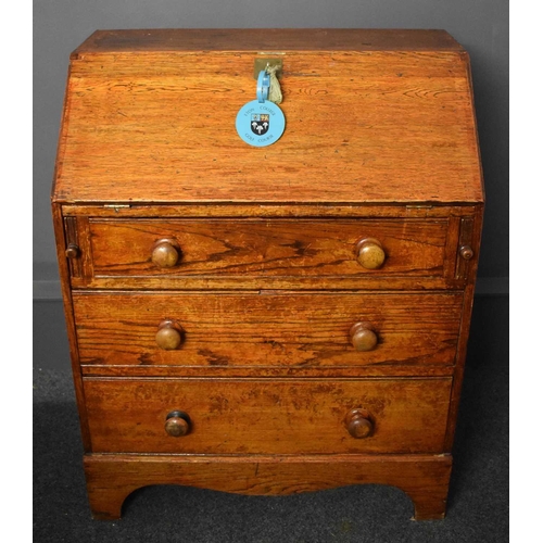 50 - An old Etonian Victorian elm bureau bearing residual student graffiti and key with Eton College tag,... 