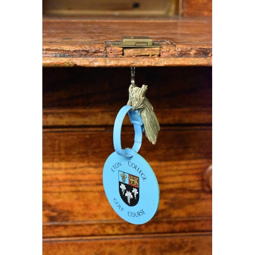 50 - An old Etonian Victorian elm bureau bearing residual student graffiti and key with Eton College tag,... 