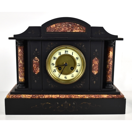 243a - A Victorian black slate and red marble over mantle clock, chimes every half hour and hour.