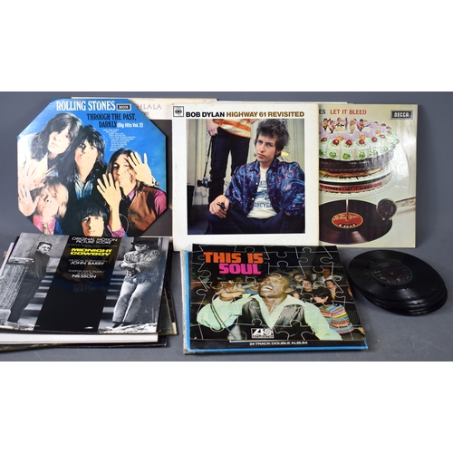 239a - A quantity of LP and single records to include Rolling Stones, Bob Dylan and others.