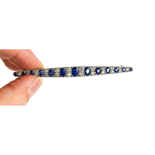 1 - An impressive diamond and cornflower blue sapphire brooch, of marquise form set with thirteen gradua... 